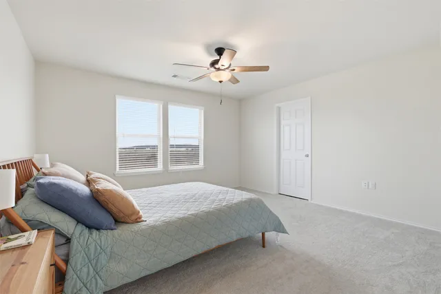 a bedroom with a bed and window