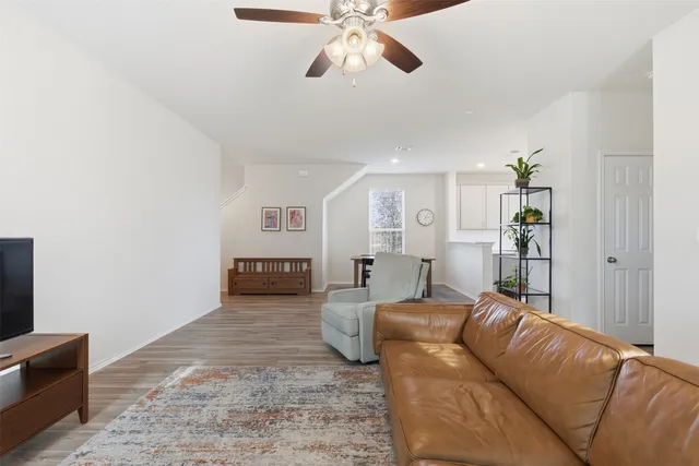 a living room with furniture and wooden floor