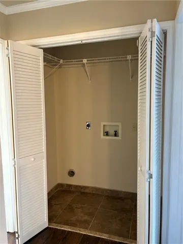 an empty room with wooden floor ceiling fan and windows