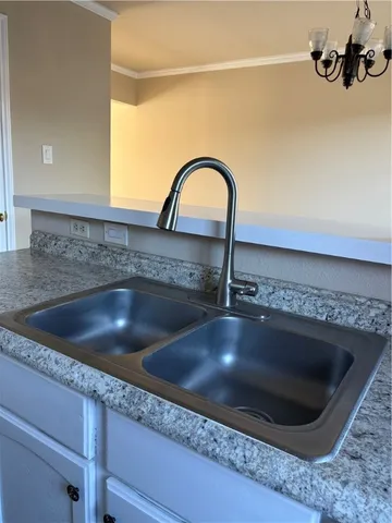 a kitchen with cabinets and window