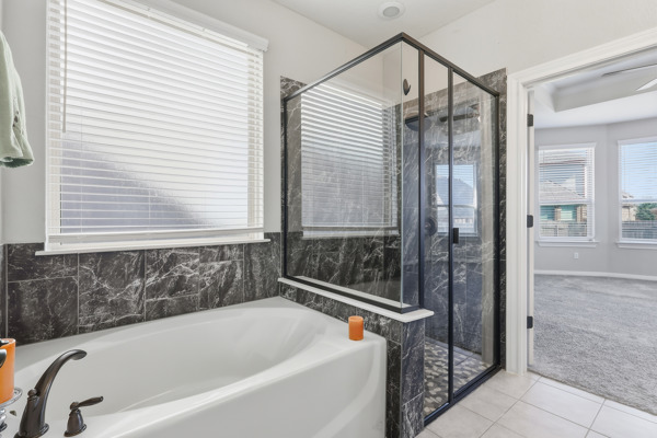 3604 Chaff Lane Pflugerville, TX 78660 - Photo 15 of 26 a bathroom with a bathtub and a shower