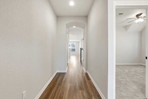 3604 Chaff Lane Pflugerville, TX 78660 - Photo 16 of 26 a view of a hallway with wooden floor and a bathroom