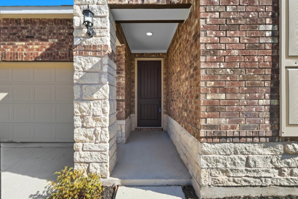 3604 Chaff Lane Pflugerville, TX 78660 - Photo 3 of 26 a hallway with beautiful frames and flower vase