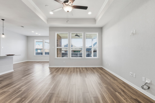 3604 Chaff Lane Pflugerville, TX 78660 - Photo 9 of 26 an empty room with wooden floor and windows