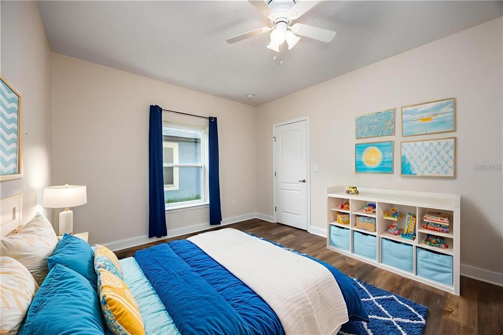 8216 Northwest 54th Street Gainesville, FL 32653 - Photo 15 of 58 a bedroom with a bed and a chandelier