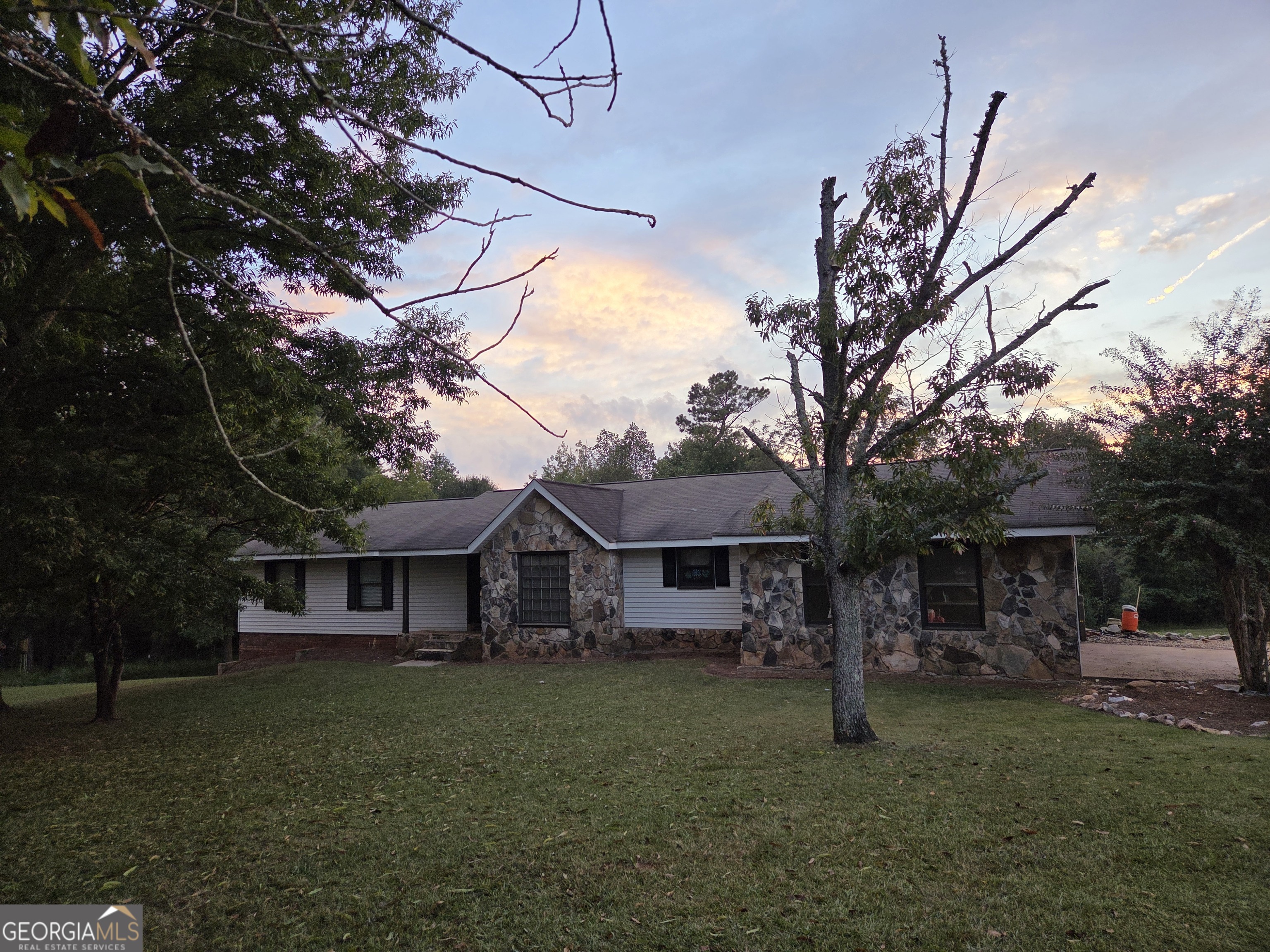 697 Steele Road Griffin, GA 30223 - Photo 1 of 1 a front view of a house with a garden