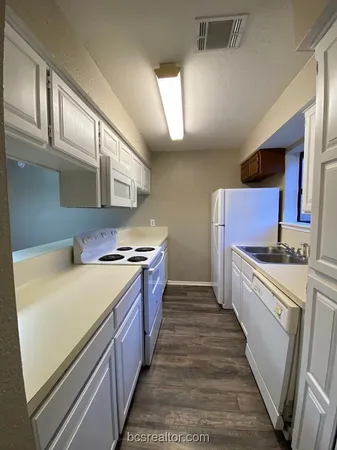 a kitchen with stainless steel appliances granite countertop a stove and a sink