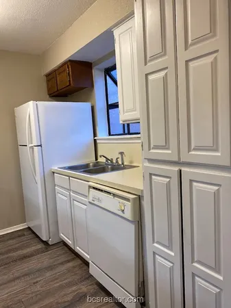 a view of front door with washer and dryer