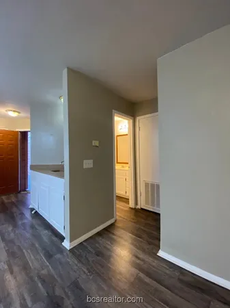 a view of hallway with wooden floor