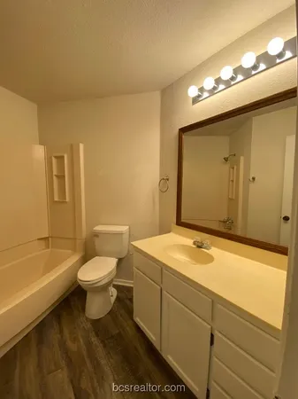 a bathroom with a sink a toilet and bathtub