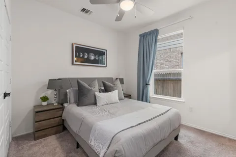 a bedroom with bed and window