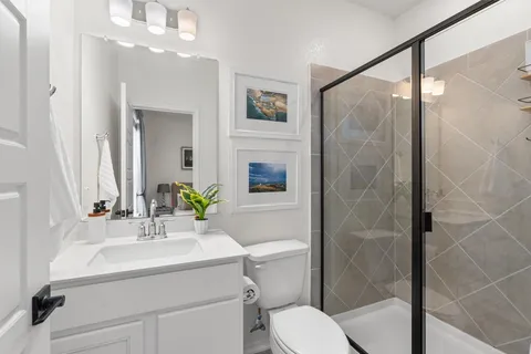 a bathroom with a sink toilet and shower