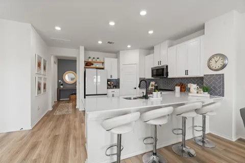 a large kitchen with lots of counter space and stainless steel appliances