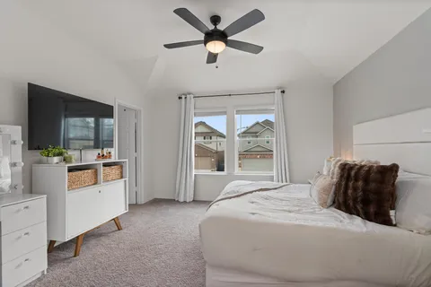 a bedroom with a large bed and a window