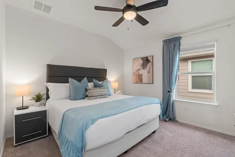 a bedroom with a bed and a window
