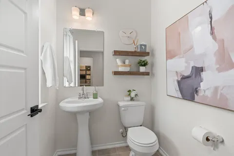 a bathroom with a sink mirror toilet and vanity