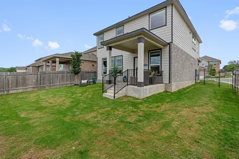 a view of a house with a yard and deck
