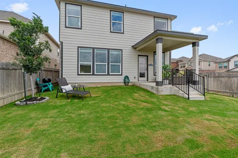 a view of a house with a yard and sitting area