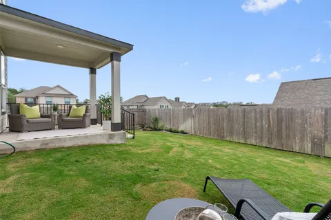 a backyard of a house with table and chairs