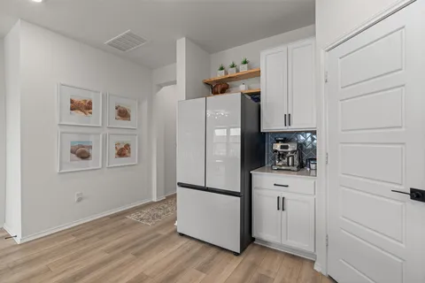 a kitchen with stainless steel appliances a refrigerator and cabinets