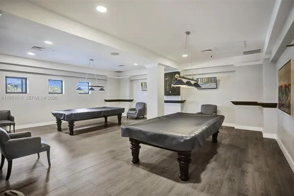 a living room with lots of furniture and a wooden floor