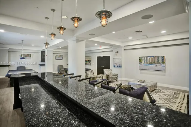 a view of a dining room with furniture and chandelier
