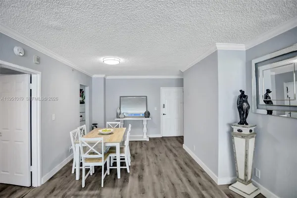 a dining room with furniture and wooden floor