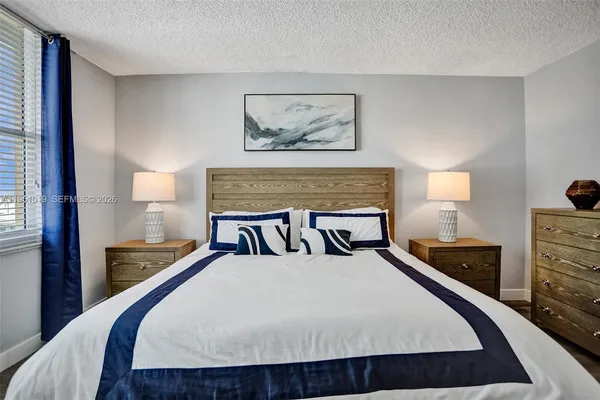 a bed sitting in a bedroom with a balcony