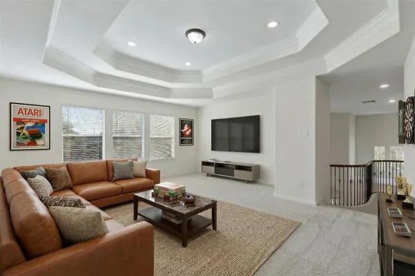 a living room with furniture flat screen tv and a large window