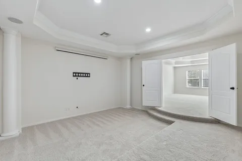 a bedroom with a bed and glass windows