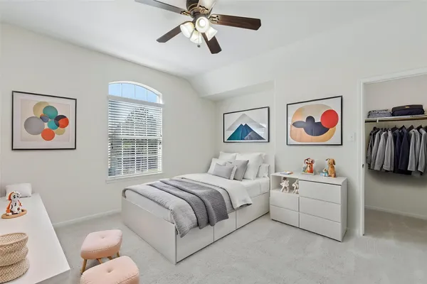 a bedroom with a bed and a potted plant