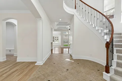 a view of entryway and hall with a front door