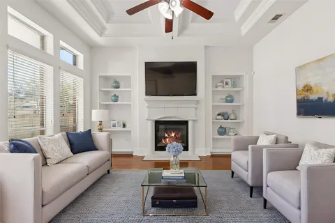a living room with furniture fireplace and flat screen tv