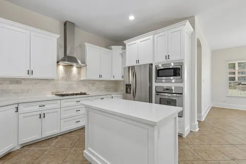 a kitchen with stainless steel appliances a refrigerator sink and cabinets
