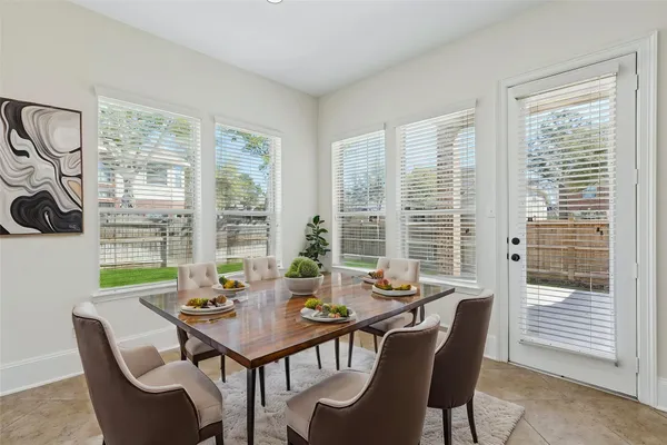 a view of a dining room with furniture and windows