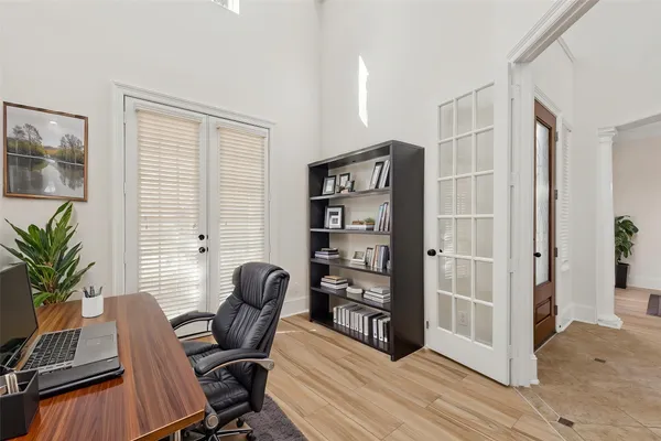 a view of a workspace with furniture and a window