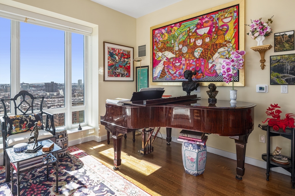 400 Stuart Street, Unit 17C Boston, MA 02116 - Photo 4 of 19 a living room with furniture and a flat screen tv