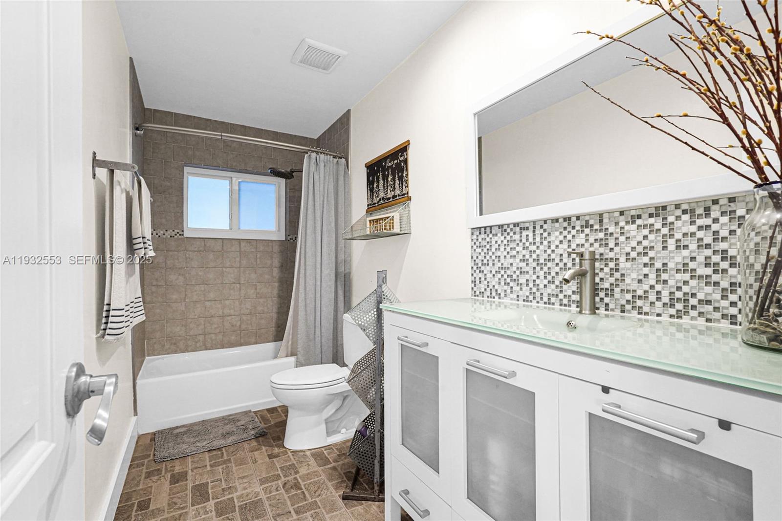 11561 Southwest 121st Avenue Miami, FL 33186 - Photo 14 of 30 a bathroom with a sink a toilet and shower