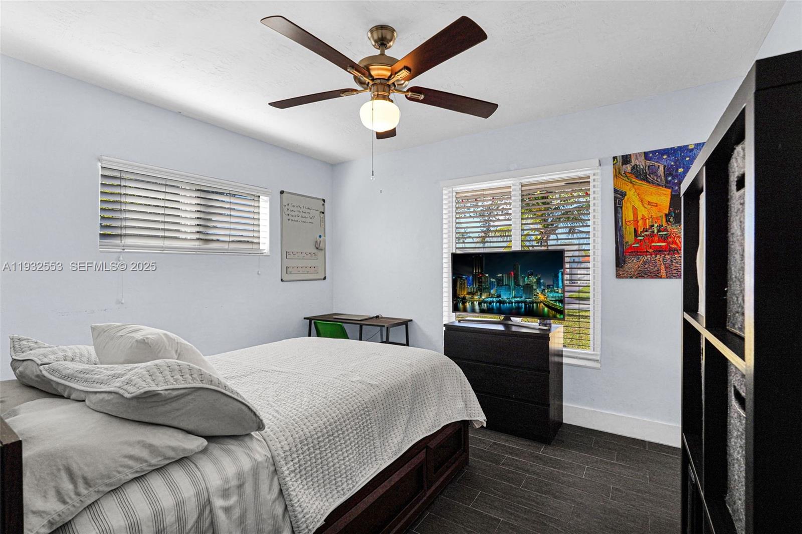 11561 Southwest 121st Avenue Miami, FL 33186 - Photo 16 of 30 a bedroom with a bed and a flat screen tv