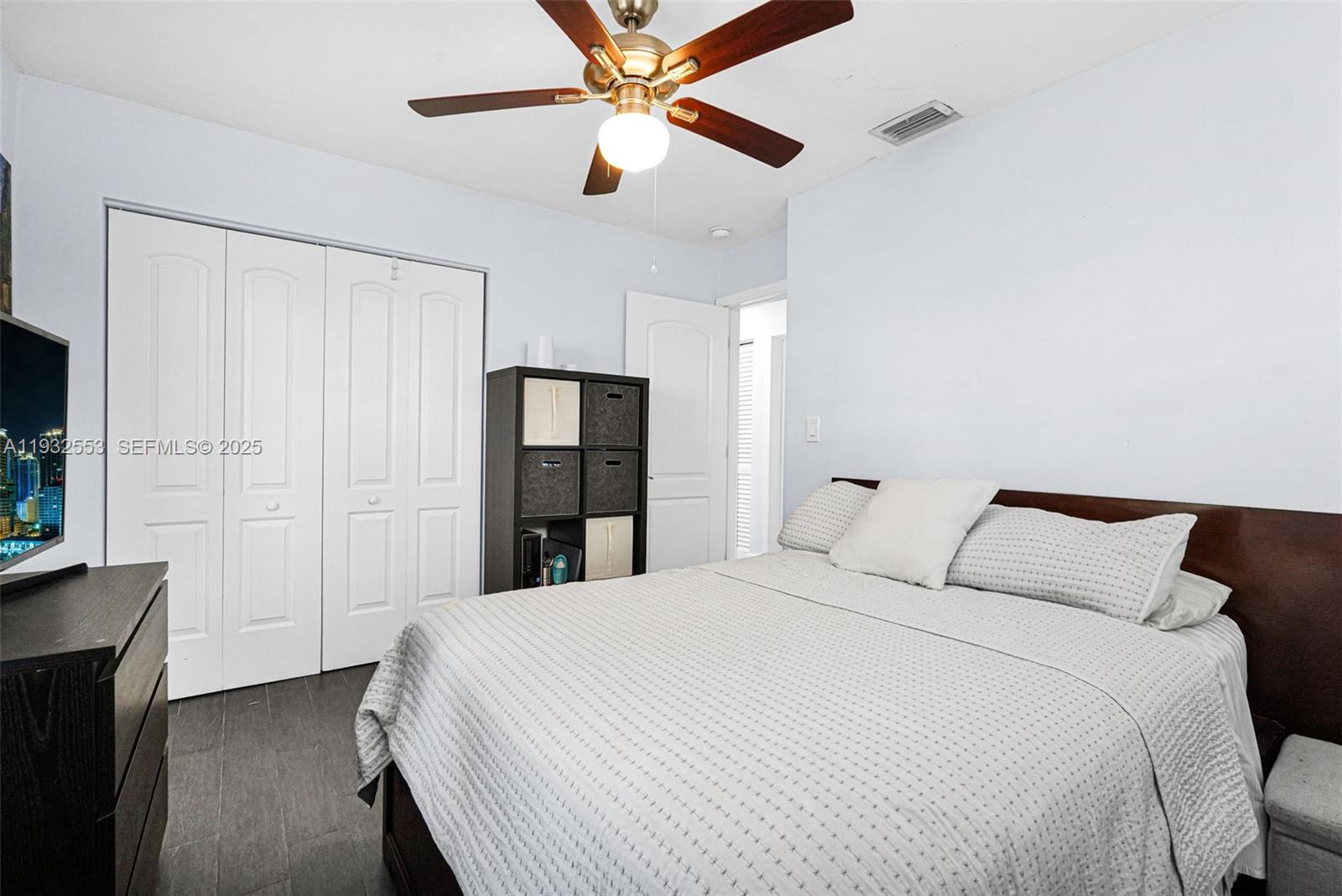 11561 Southwest 121st Avenue Miami, FL 33186 - Photo 17 of 30 a bedroom with a bed and a ceiling fan