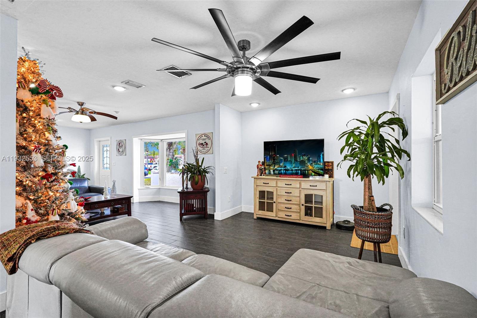 11561 Southwest 121st Avenue Miami, FL 33186 - Photo 18 of 30 a living room with furniture a flat screen tv and a potted plant