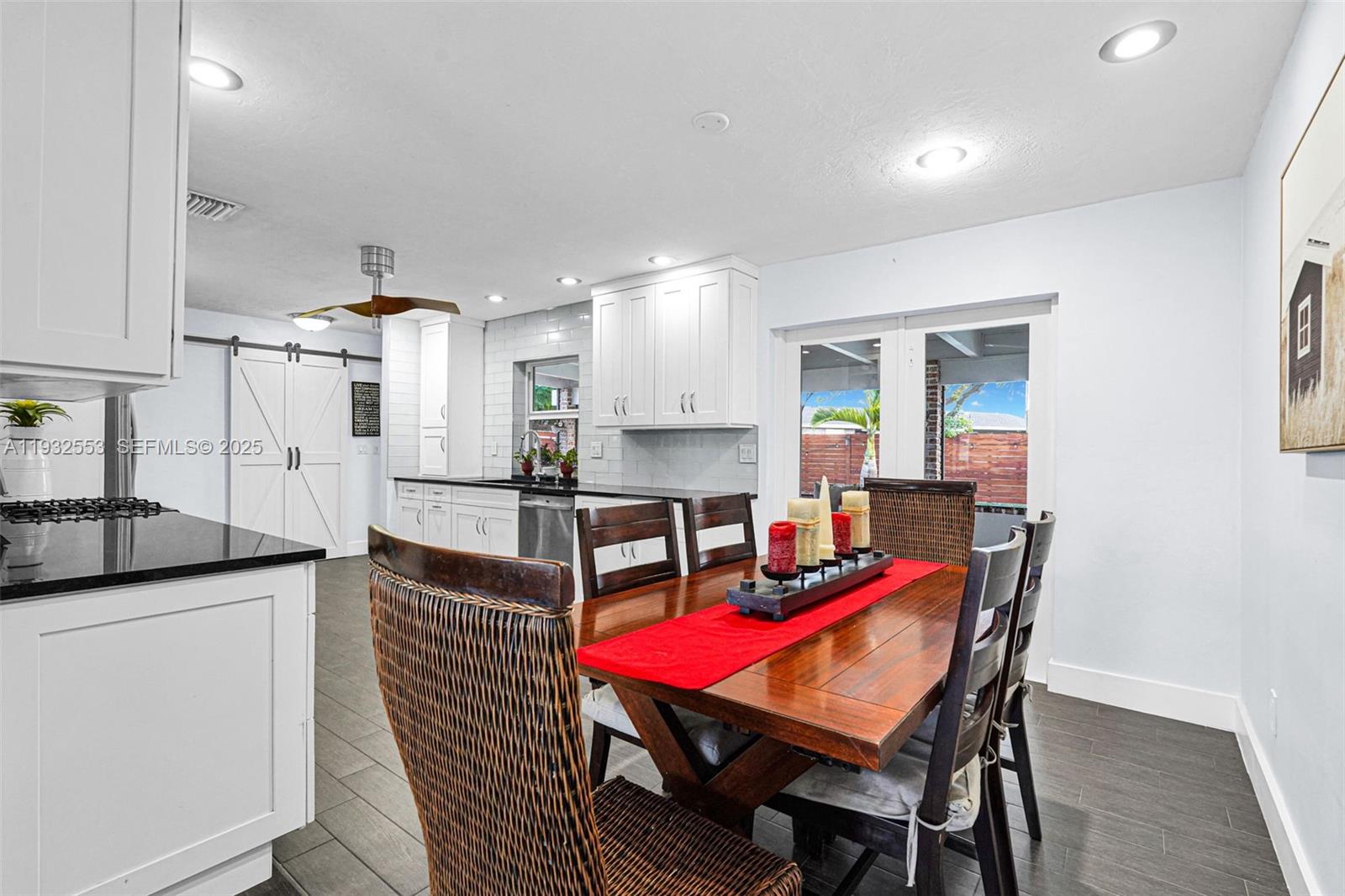 11561 Southwest 121st Avenue Miami, FL 33186 - Photo 22 of 30 a room with stainless steel appliances kitchen island granite countertop a dining table chairs and a refrigerator
