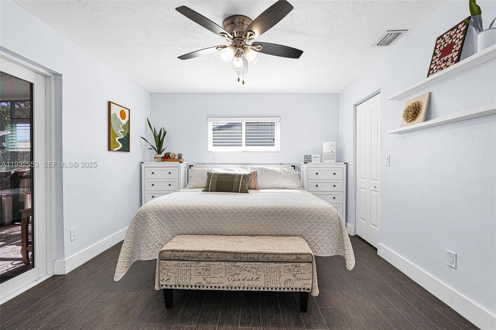 11561 Southwest 121st Avenue Miami, FL 33186 - Photo 28 of 30 a bedroom with a bed and a chandelier