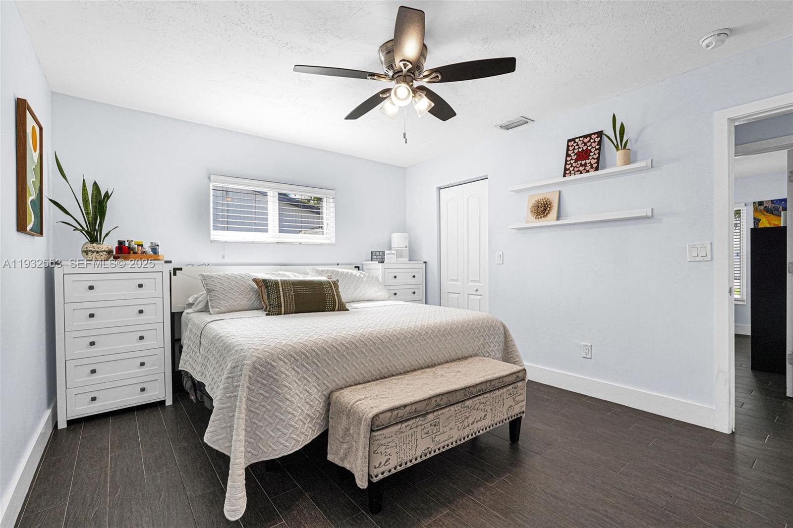 11561 Southwest 121st Avenue Miami, FL 33186 - Photo 29 of 30 a bedroom with a bed and a chandelier