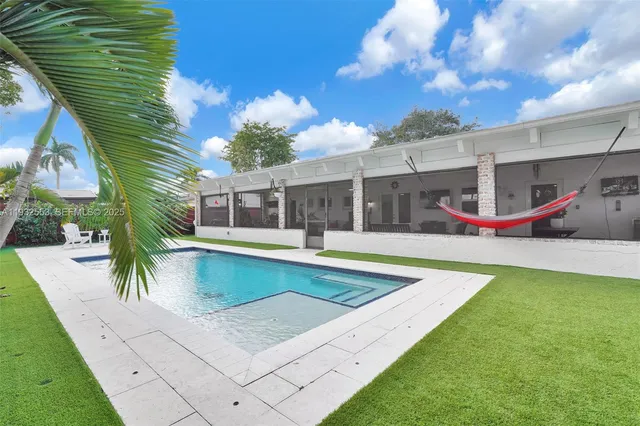 a view of swimming pool with a yard