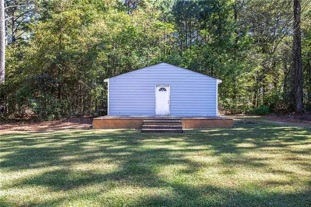 a backyard of a house with table and chairs