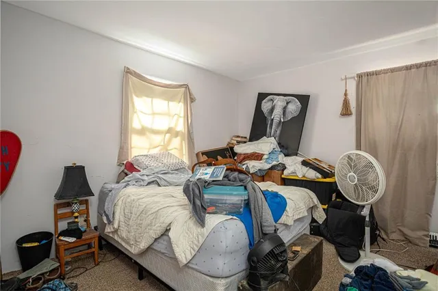 a bed room with a bed and a chair