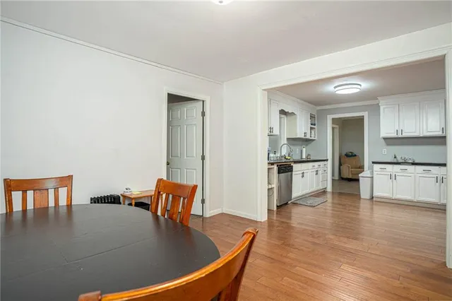 a kitchen with stainless steel appliances granite countertop a stove refrigerator and a view of living room