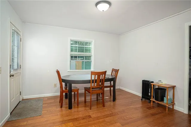 a view of a dining room with furniture and wooden floor