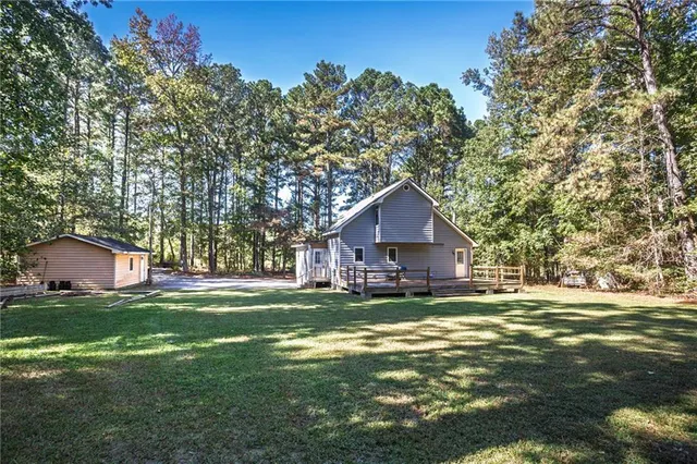 a backyard of a house with table and chairs